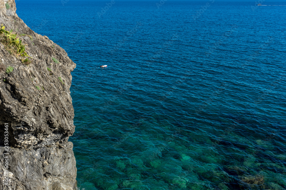 Italy, Cinque Terre, Monterosso, a close up of a rock next to a body of water