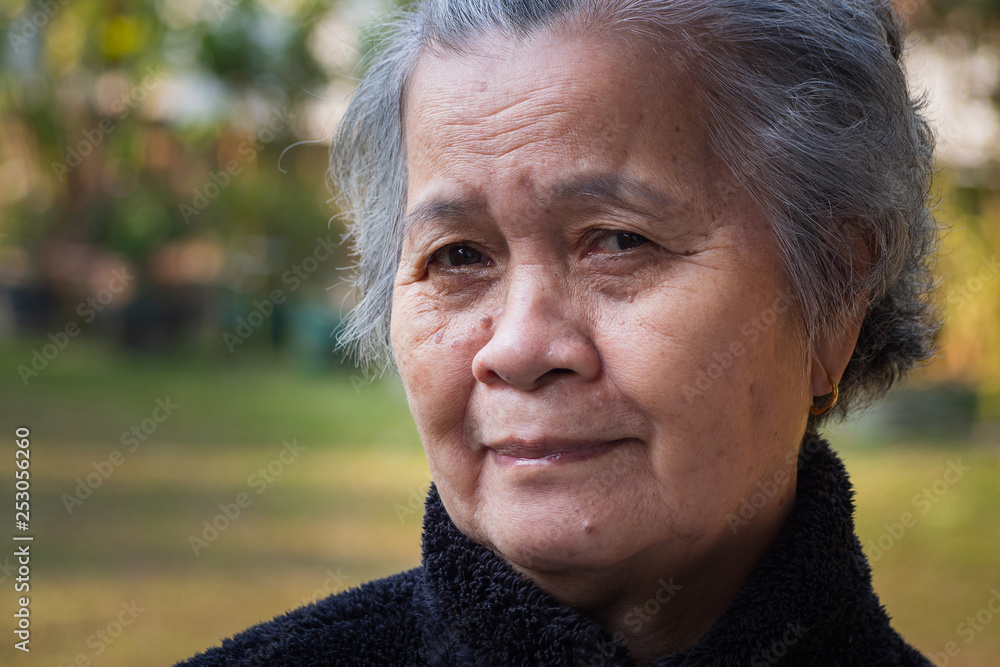 Portrait of a happy senior woman smiling in her garden.