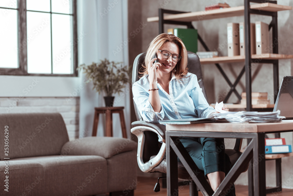 Beautiful businesswoman feeling good receiving call from husband Beautiful businesswoman feeling good receiving call from husband