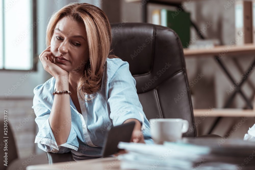 Businesswoman wearing stylish bracelet holding new smartphone Businesswoman wearing stylish bracelet holding new smartphone