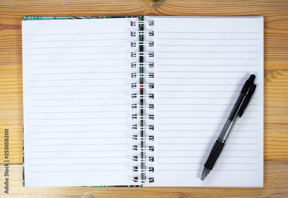 Blank notebook with striped papers and pen Blank notebook with striped papers and pen