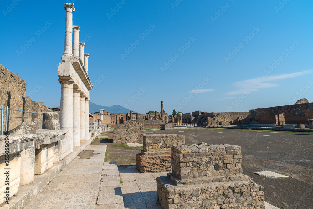 POMPEII, ITALY - 8 August 2015: Ruins of antique roman temple in Pompeii near volcano Vesuvius, Naples, Italy.