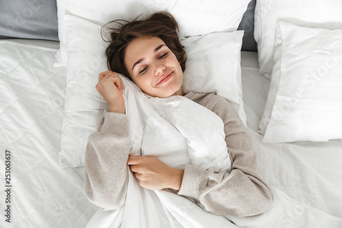 Smiling young girl relaxing in bed