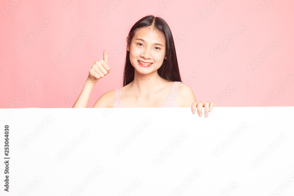 Young Asian woman show thumbs up with blank sign. Young Asian woman show thumbs up with blank sign.