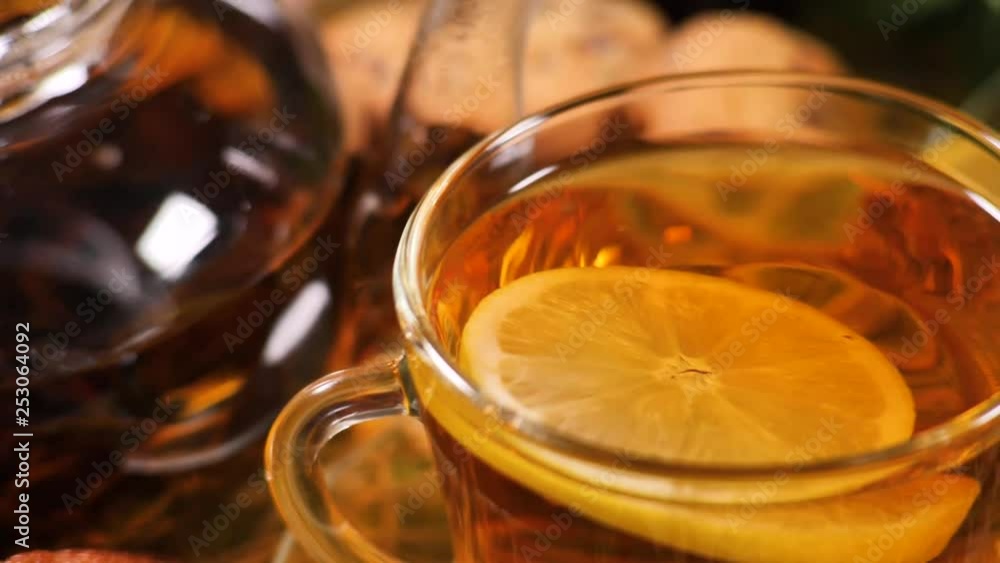 Glass teapot and cup with tea and lemon slice Glass teapot and cup with tea and lemon slice