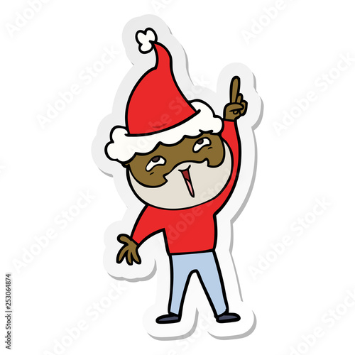 sticker cartoon of a happy bearded man wearing santa hat
