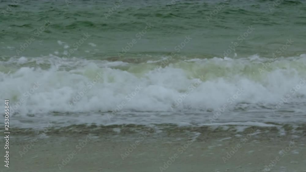 Rough sea with snow storm. Winter sea storm wave strikes the sandy coast. Coastal seascape Rough sea with snow storm. Winter sea storm wave strikes the sandy coast. Coastal seascape