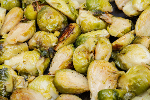 Roasted Organic Brussels sprouts in a Cast-Iron Skillet like background.