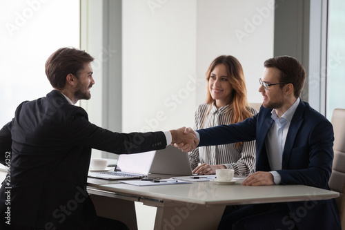 Wallpaper Mural Business partners shaking hands negotiating at office meeting, collaboration concept Torontodigital.ca