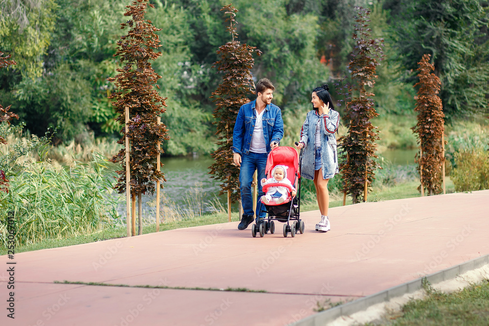 mom and dad are walking in the park with their daughter in a stroller, a beautiful sunny day, a beautiful family mom and dad are walking in the park with their daughter in a stroller, a beautiful sunny day, a beautiful family