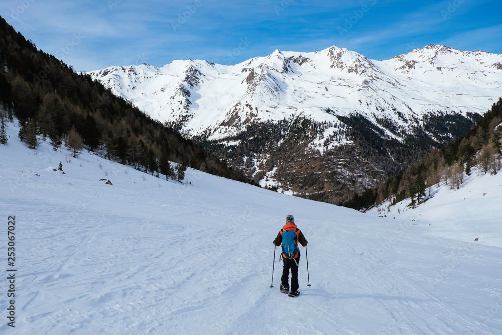 Woman on a snowshoe tour in the italian alps