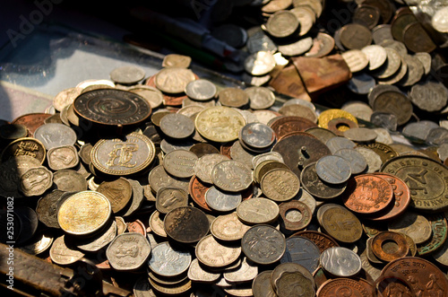 Close up of a collection of old coins kept at a roadside vendor's shop in Fatehpuri, Chandni Chowk, Old Delhi, India for buying / exchange. Numismatics visit this place to buy coins. photo