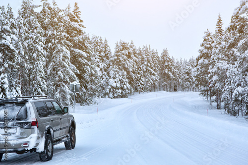 Suv car stay on roadside of winter road. Family trip to ski resort. Winter holidays adventure. car on winter road