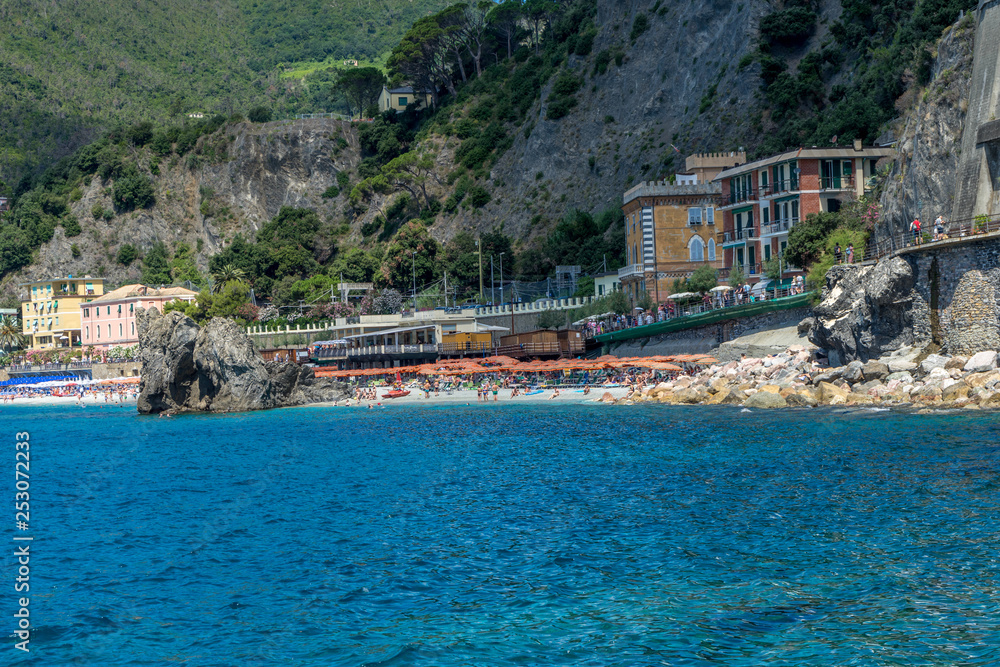 Italy, Cinque Terre, Tourists enjoying the beach and sunshine at Monterosso al mare