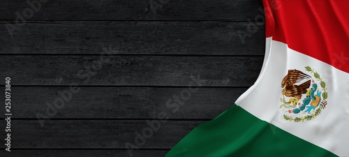 Fotografie Flag of the Mexico, fabric on dark wood.