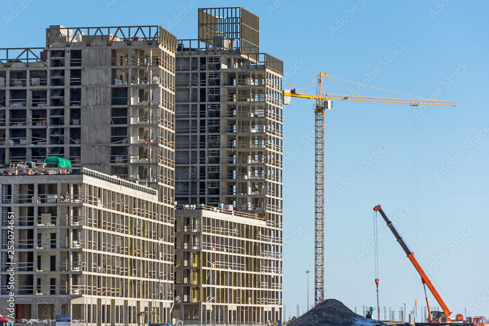 Construction of a residential building and cranes, real estate