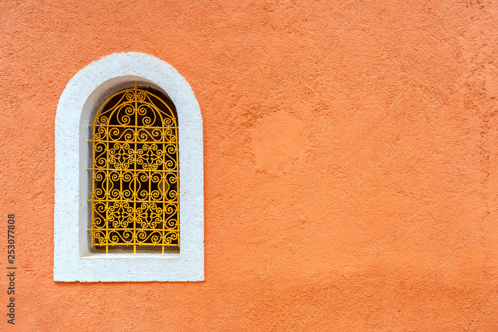 Typical window with decorative grille on colour wall. Marrakech, Morocco