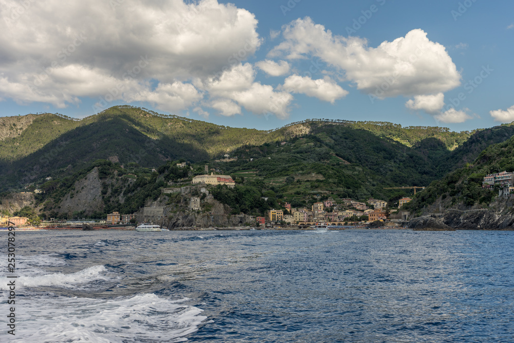Italy, Cinque Terre, Monterosso, a body of water with a mountain in the background