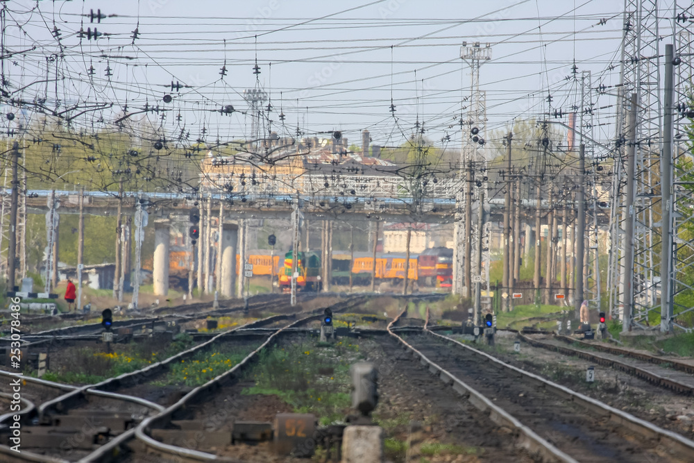 electric pole and wires over train tracks