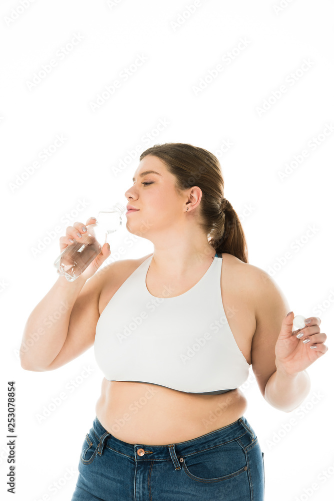 overweight woman drinking water from bottle isolated on white overweight woman drinking water from bottle isolated on white