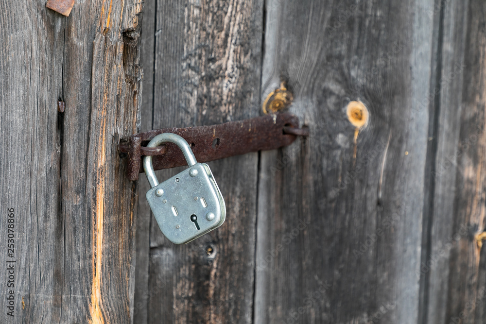 padlock on old wooden door padlock on old wooden door