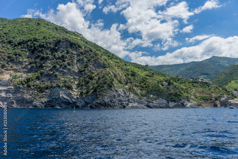 Italy, Cinque Terre, Monterosso, a large body of water with a mountain in the background