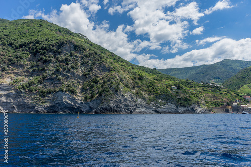 Italy  Cinque Terre  Monterosso  a large body of water with a mountain in the background