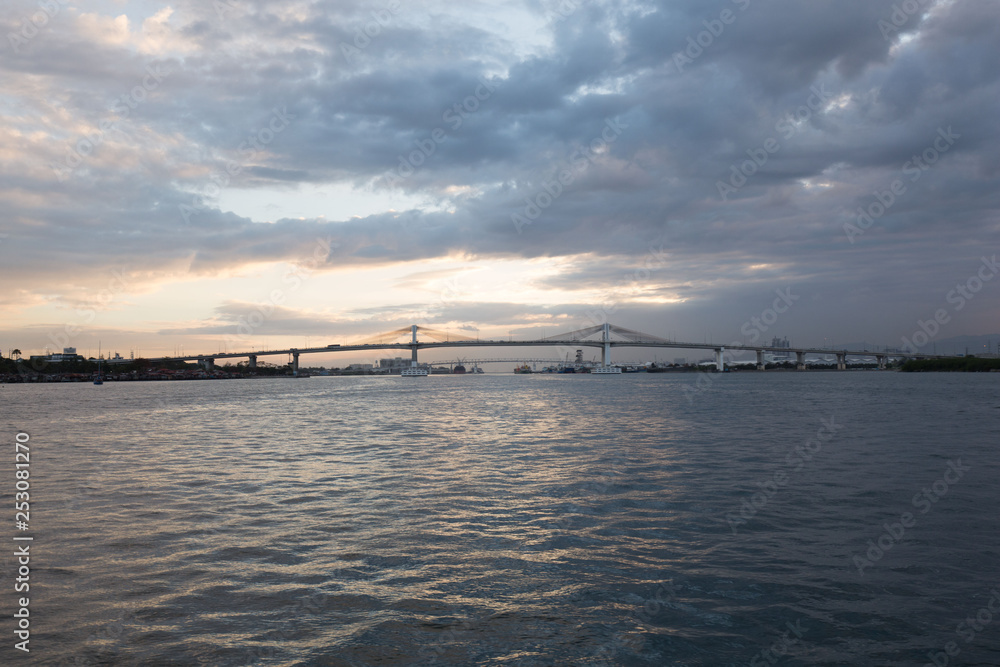 two mactaqn bridges viewpoint from open sea site in dusk sunset with cloudy sky