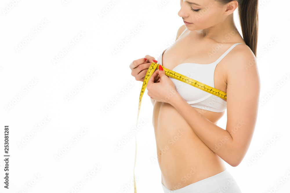sexy slim woman in underwear measuring bust with centimeter isolated on white sexy slim woman in underwear measuring bust with centimeter isolated on white