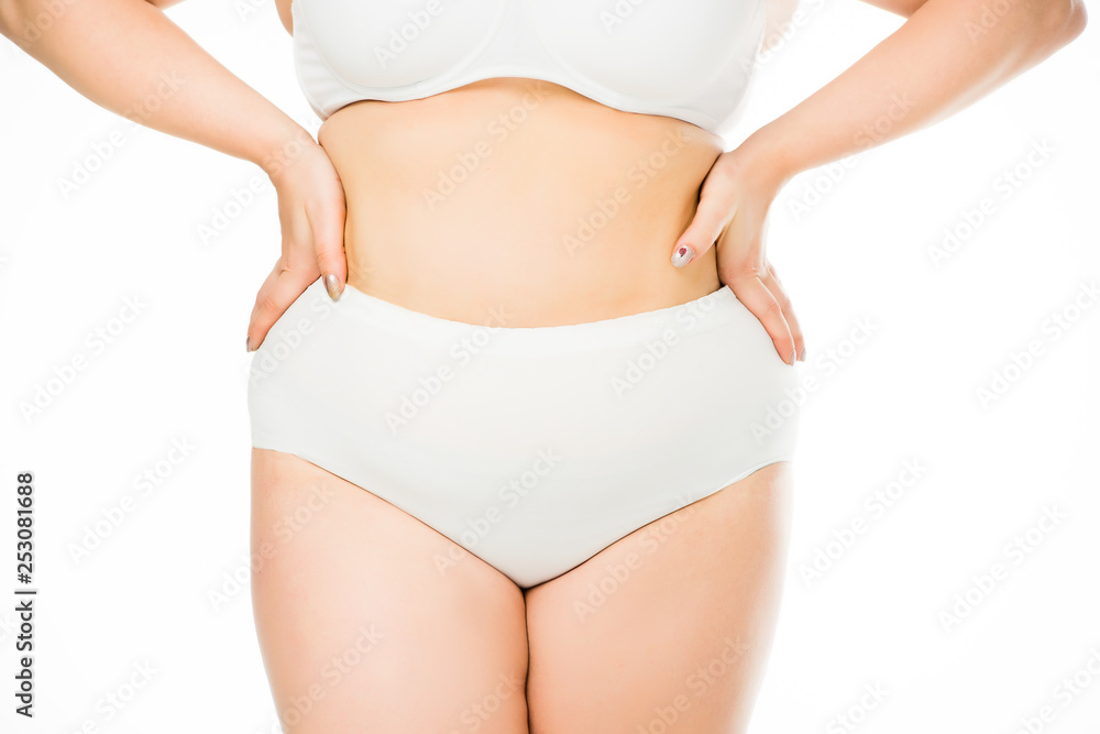 cropped view of overweight woman posing with hands on waist isolated on white, body positivity concept cropped view of overweight woman posing with hands on waist isolated on white, body positivity concept