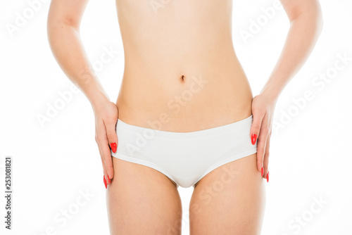 partial view of slim woman posing with hands on hips isolated on white © LIGHTFIELD STUDIOS