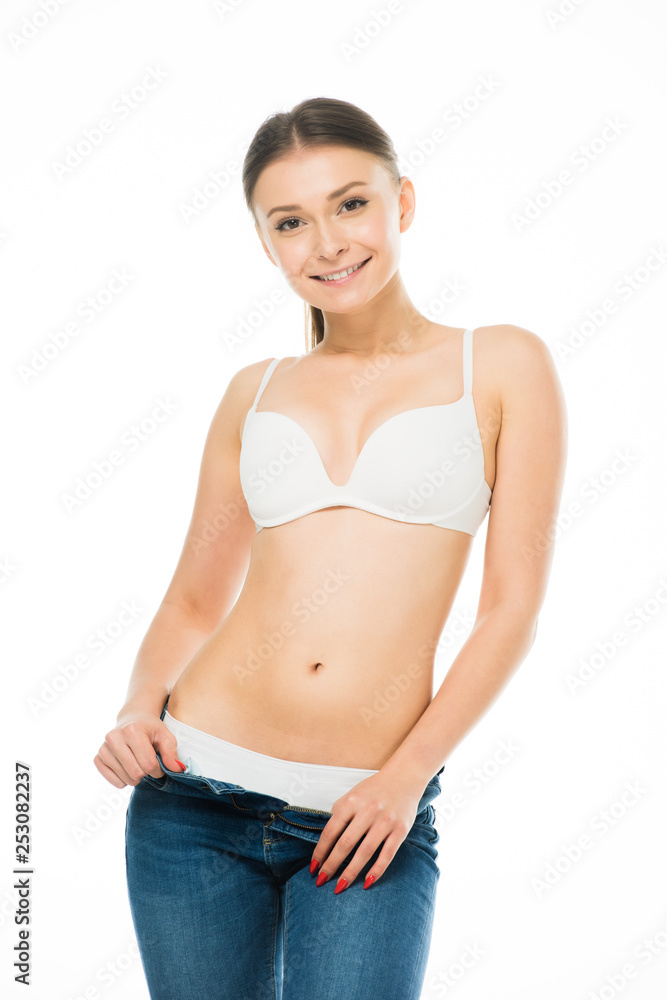 happy slim woman in underwear taking off blue jeans isolated on white happy slim woman in underwear taking off blue jeans isolated on white