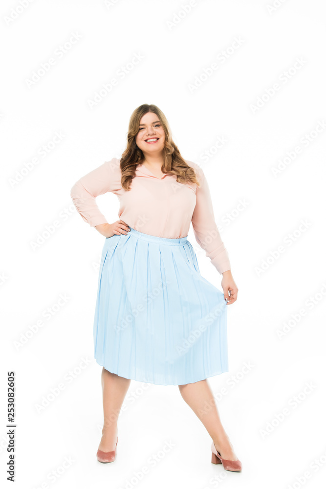 happy elegant overweight woman holding skirt isolated on white
