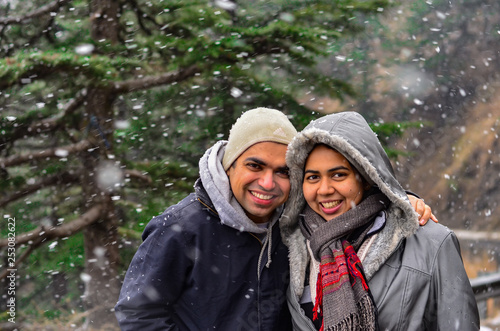 Wallpaper Mural Young Indian couple enjoying their first snowfall during winter holidays in Kufri, Shimla, Himachal Pradesh. It is a popular winter getaway where people come to enjoy snowfall, skiing & winter sports Torontodigital.ca