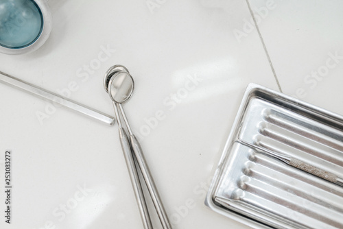 Professional Dentist tools in dental office: dentist mirror. Dental Hygiene and Health conceptual image