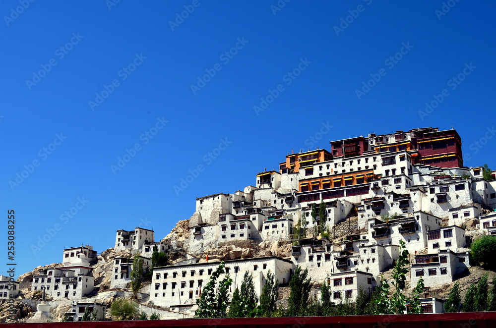 Full view of Thiksay Gompa / Monastery which is a gompa affiliated with the Gelug sect of Tibetan Buddhism. It's located on top of a hill in Thiksey, 19 kilometres east of Leh, in Ladakh, India.