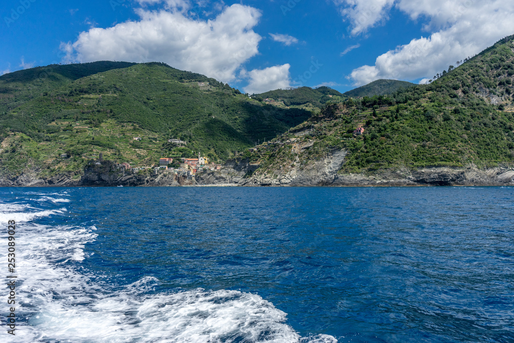 Italy, Cinque Terre, Monterosso, a body of water with a mountain in the background