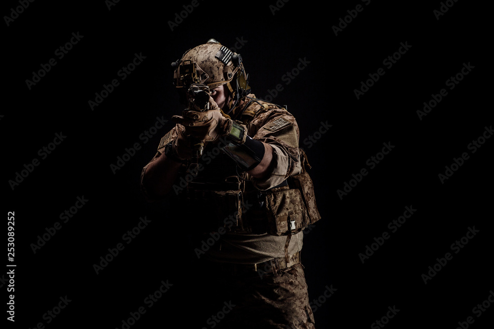 Special forces United States soldier or private military contractor holding rifle. Image on a black background. war, army and people concept Special forces United States soldier or private military contractor holding rifle. Image on a black background. war, army and people concept