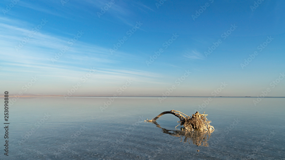 Fototapeta premium A vast salt lake at the bottom of the Danakil Depression is a scenic tourist destination as well as a source of salt for Afar people who have traded this valuable commodity for hundreds of years.