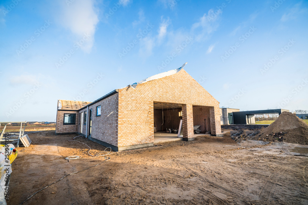 Brick house construction site in a new neighborhood Brick house construction site in a new neighborhood