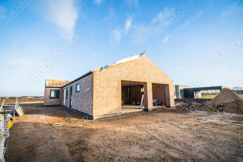 Brick house construction site in a new neighborhood © Polarpx