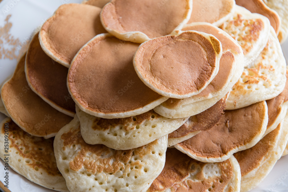 Small pancakes on a plate.