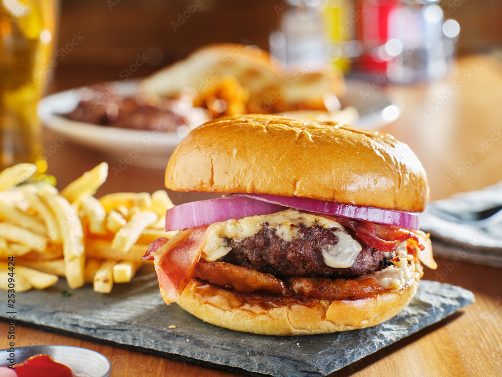 western style bacon burger with onion rings and bbq sauce Stock Photo |  Adobe Stock