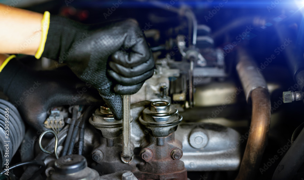 Auto mechanic Preparing For the work. Mechanic with Stainless Steel Wrench in Hand.Close up of hands mechanic doing car service and maintenance.Engine Maintenance concept Auto mechanic Preparing For the work. Mechanic with Stainless Steel Wrench in Hand.Close up of hands mechanic doing car service and maintenance.Engine Maintenance concept