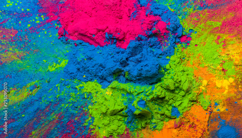 Abstract colorful Happy Holi background. Color vibrant powder on wood. Dust colored splash texture. Flat lay holi paint decoration © Ruslan Gilmanshin