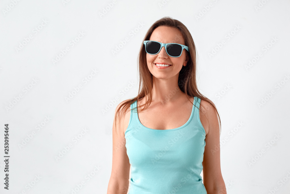 Freestyle. Woman in sunglasses standing studio isolated on white cheerful Freestyle. Woman in sunglasses standing studio isolated on white cheerful
