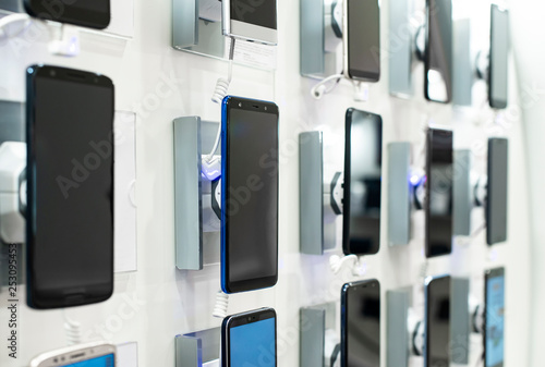 Smartphones on shelf in the store. Concept for communications and technology.