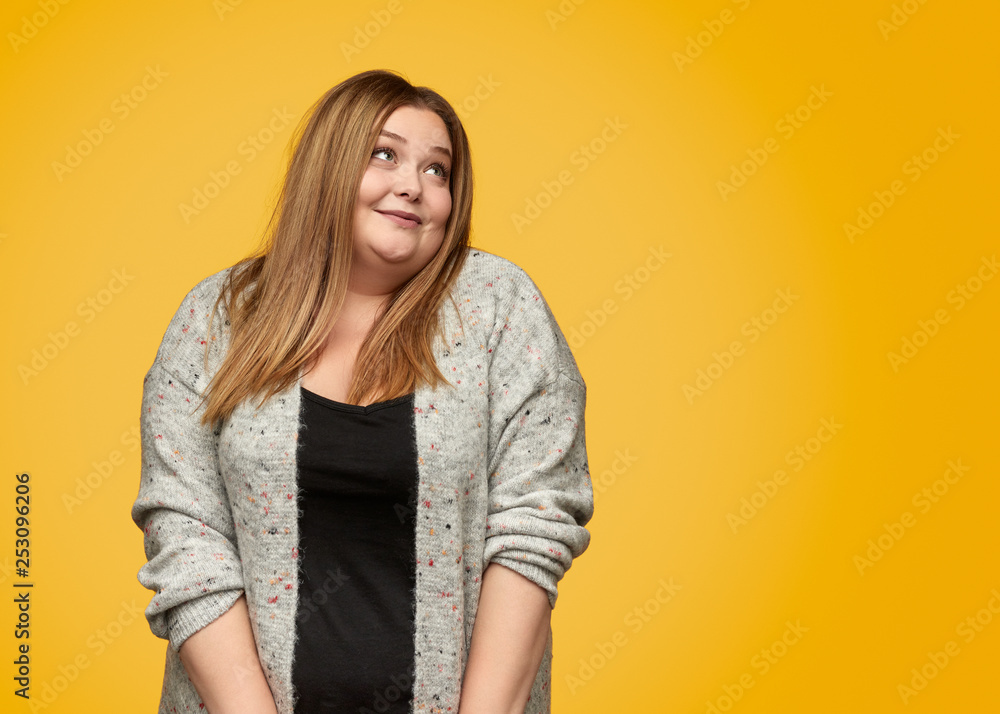 Dreamy plump woman looking away Dreamy plump woman looking away
