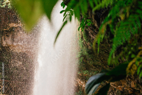 View on the Dambri waterfall in Bao Loc in Vietnam surrounded by palm leaves photo