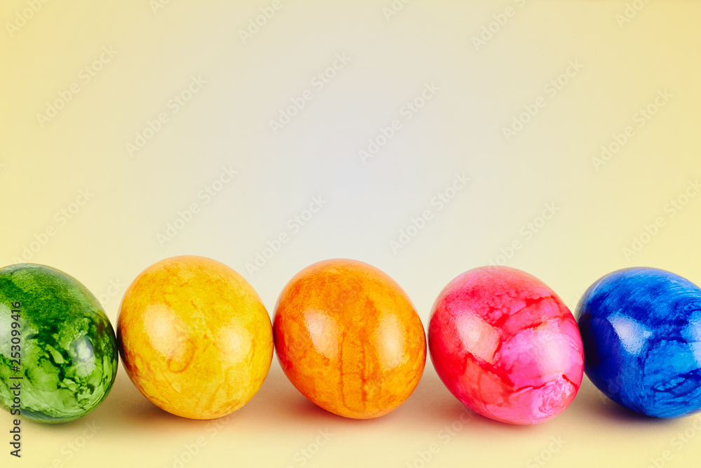 Colored Easter eggs on yellow background Colored Easter eggs on yellow background